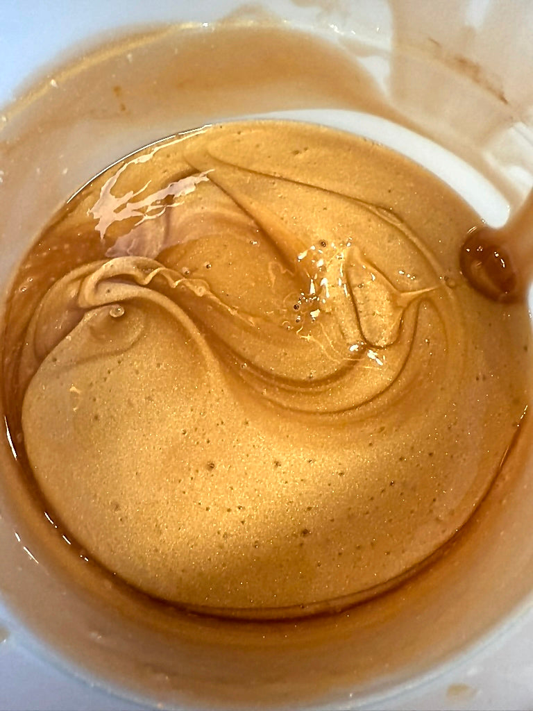 Gold shimmer swirl of Touch Me in Petals Illuminating Body Oil