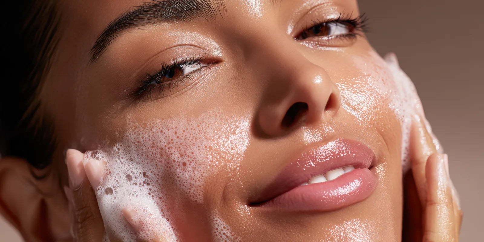 Model with eyes closed and cleansing foam on her cheek, the Frangipani and Agave Nectar Facial Cleanser ritual