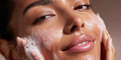 Model with eyes closed and cleansing foam on her cheek, the Frangipani and Agave Nectar Facial Cleanser ritual