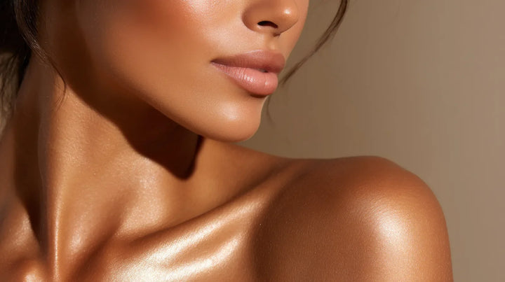 Model with luminous shoulders and collarbone in golden light